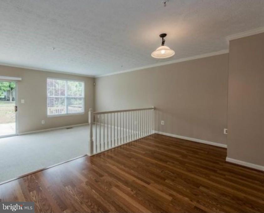 7151 Natures Road Columbia, MD 21046 - Photo 8 of 33 a view of an empty room with wooden floor and a window