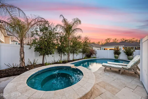 a view of swimming pool with outdoor seating and plants
