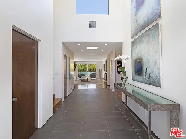 a lobby with furniture and a large mirror
