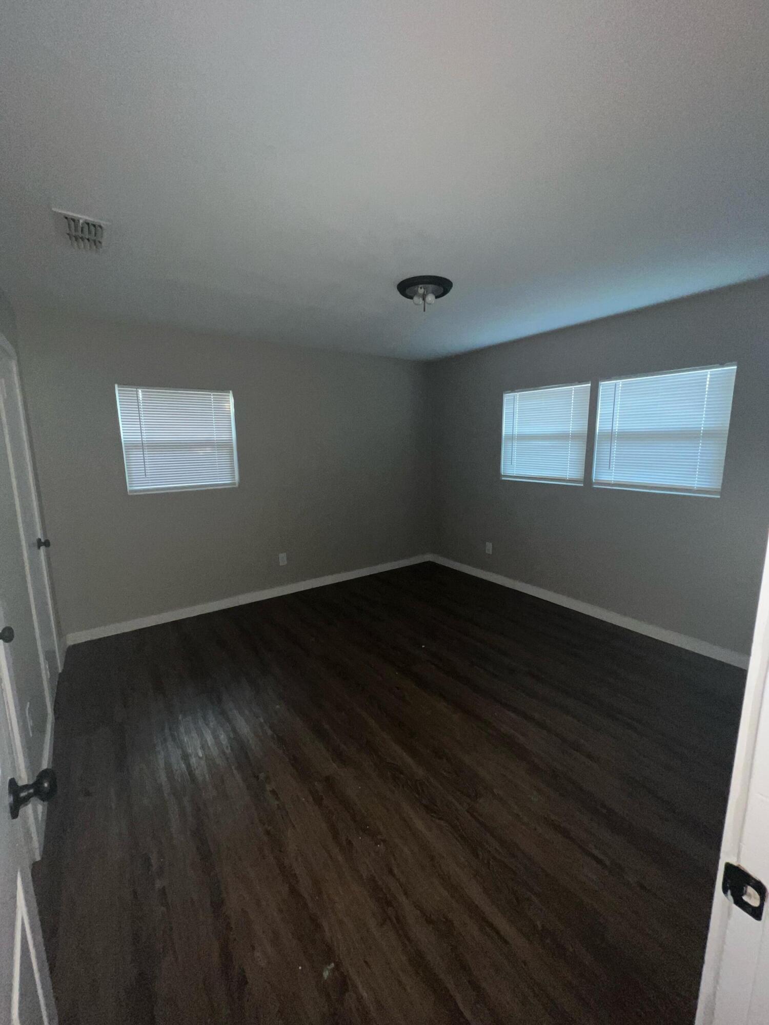 2104 22nd Street Lubbock, TX 79411 - Photo 4 of 9 an empty room with wooden floor and windows