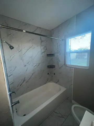 a bathroom with a bathtub and a shower