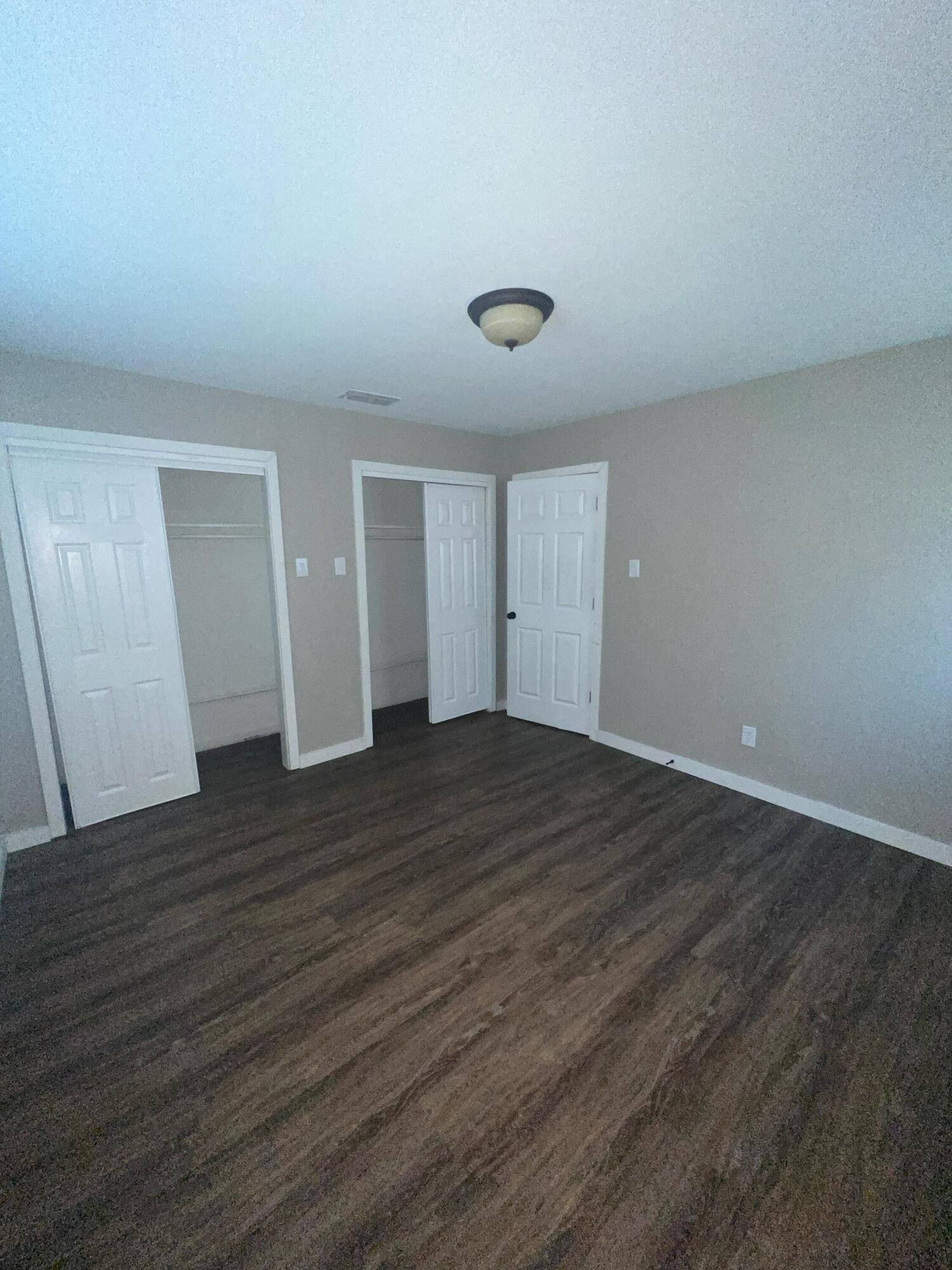 2104 22nd Street Lubbock, TX 79411 - Photo 8 of 9 a view of an empty room with wooden floor and a window
