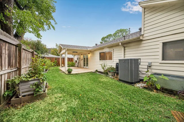 a view of a patio with couches chairs and wooden fence