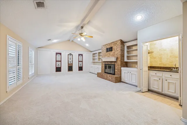 a large kitchen with window and stainless steel appliances