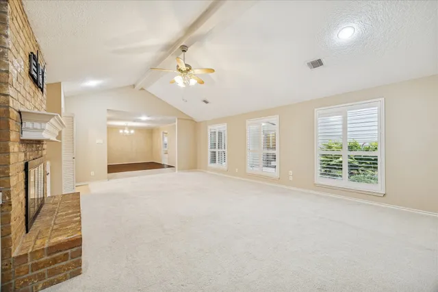 a view of an empty room with a fireplace
