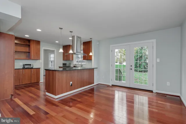 a view of kitchen with wooden floor and electronic appliances