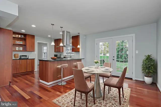 a kitchen with stainless steel appliances granite countertop a refrigerator a sink and a stove