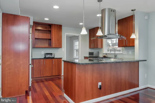 a kitchen with stainless steel appliances a refrigerator sink and stove