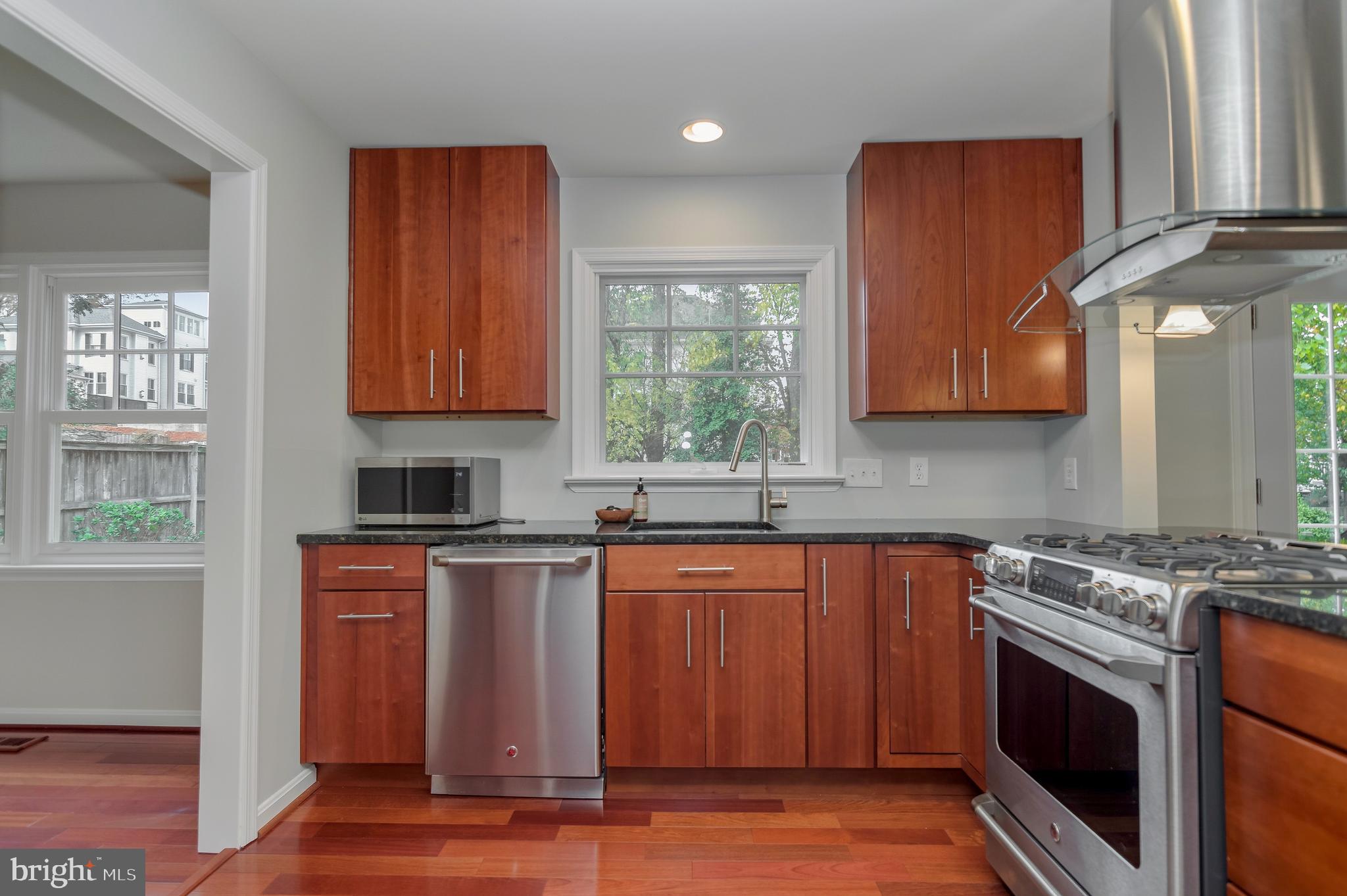 4043 20th Road North Arlington, VA 22207 - Photo 21 of 56 a kitchen with stainless steel appliances granite countertop wooden cabinets stove top oven and sink