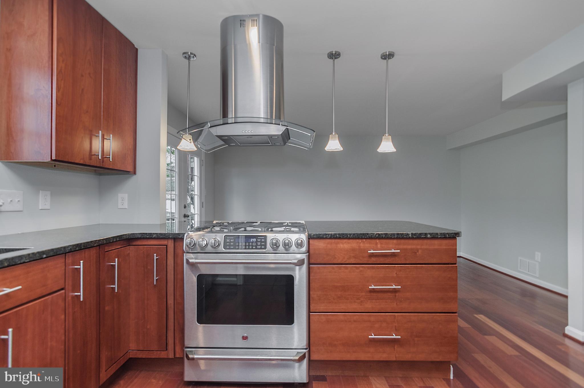 4043 20th Road North Arlington, VA 22207 - Photo 22 of 56 a kitchen with a stove and cabinets