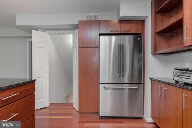 a view of a hallway with wooden floor and entryway
