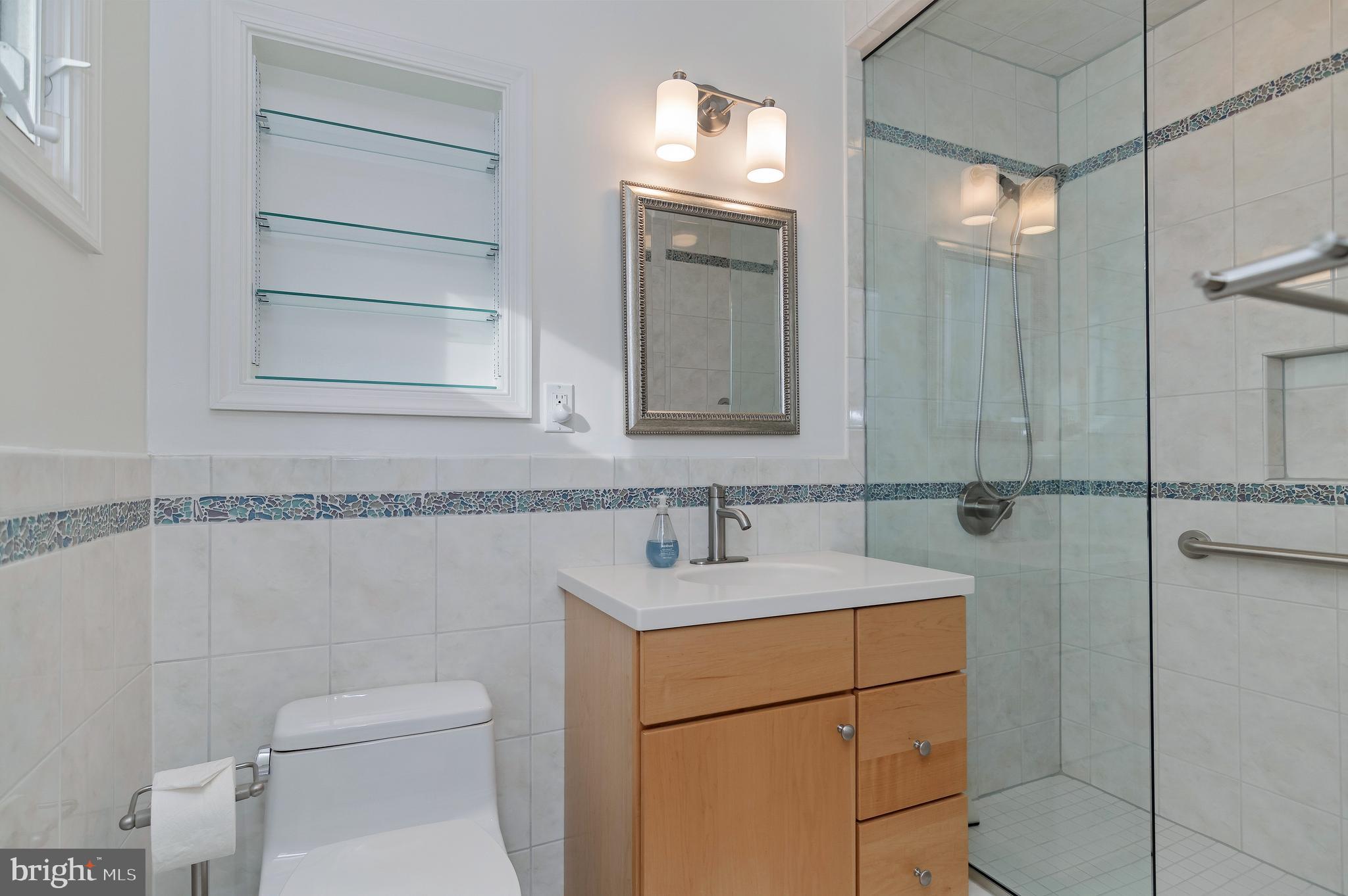 4043 20th Road North Arlington, VA 22207 - Photo 30 of 56 a bathroom with a sink toilet vanity and shower