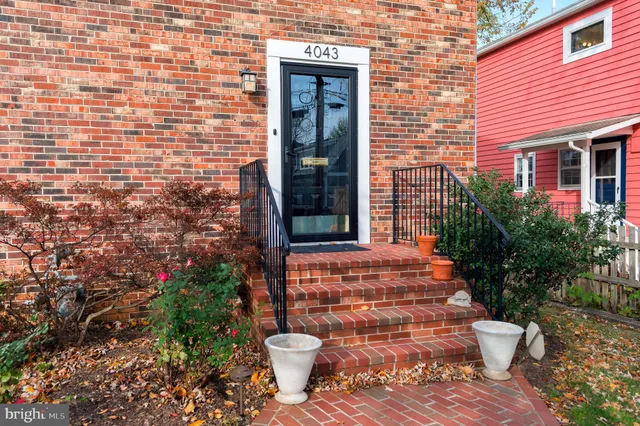 a view of a brick house with potted plants