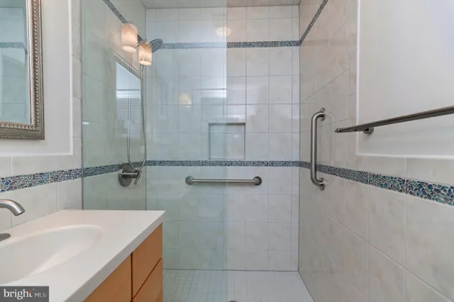 a bedroom with a large bed and a flat tv screen on dresser