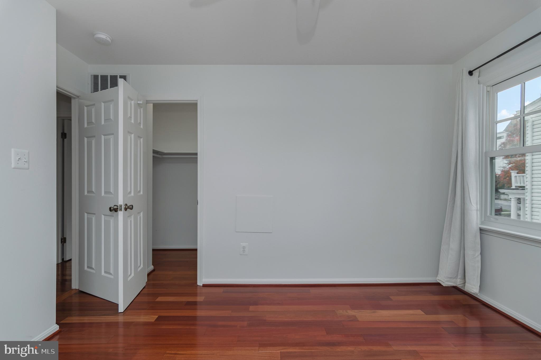 4043 20th Road North Arlington, VA 22207 - Photo 37 of 56 a view of an empty room with wooden floor and a window