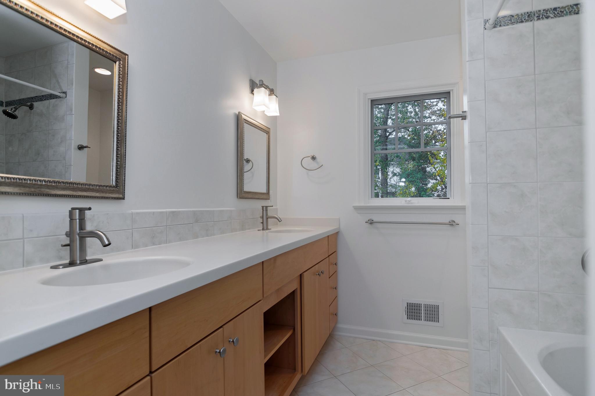 4043 20th Road North Arlington, VA 22207 - Photo 38 of 56 a bathroom with a sink double vanity and a tub