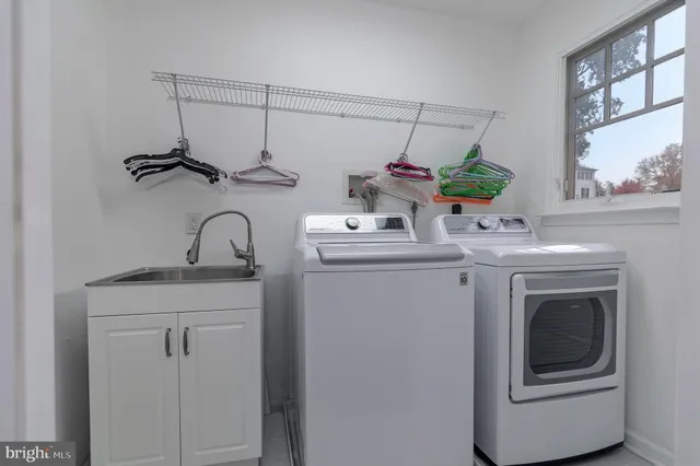 a bathroom with a granite countertop sink a mirror and shower
