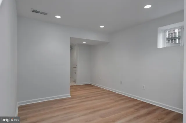 a bathroom with a toilet a sink and a mirror