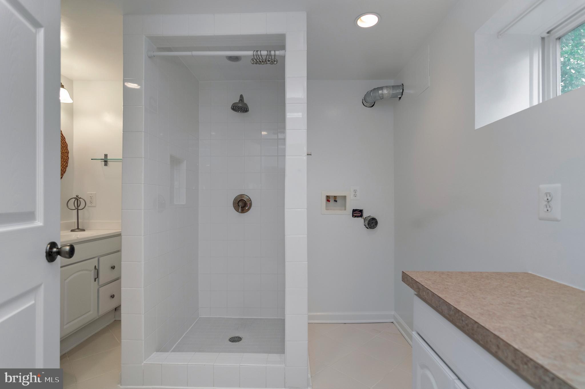 4043 20th Road North Arlington, VA 22207 - Photo 46 of 56 a bathroom with a granite countertop sink a mirror and shower