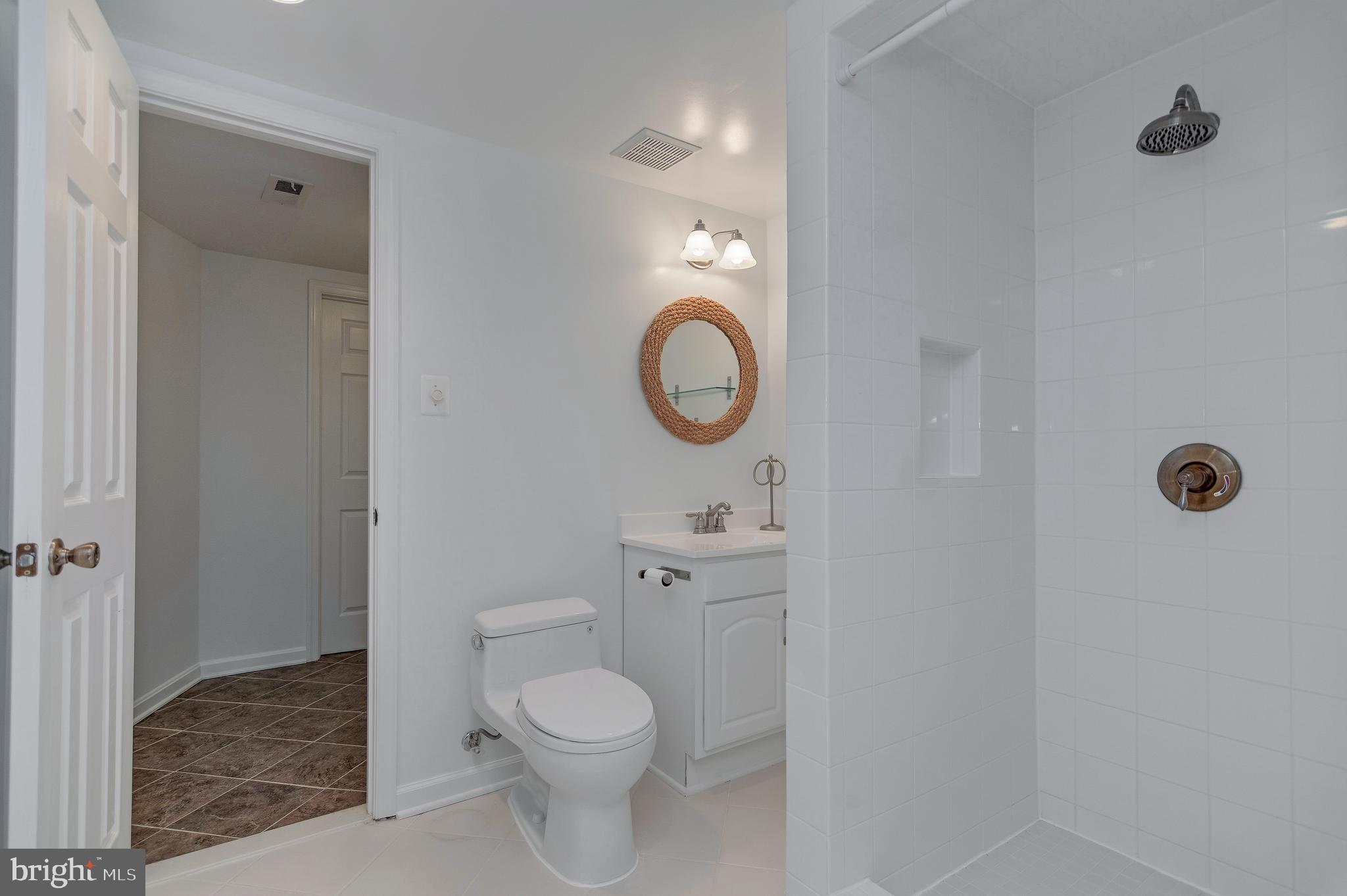 4043 20th Road North Arlington, VA 22207 - Photo 47 of 56 a bathroom with a toilet a sink and mirror