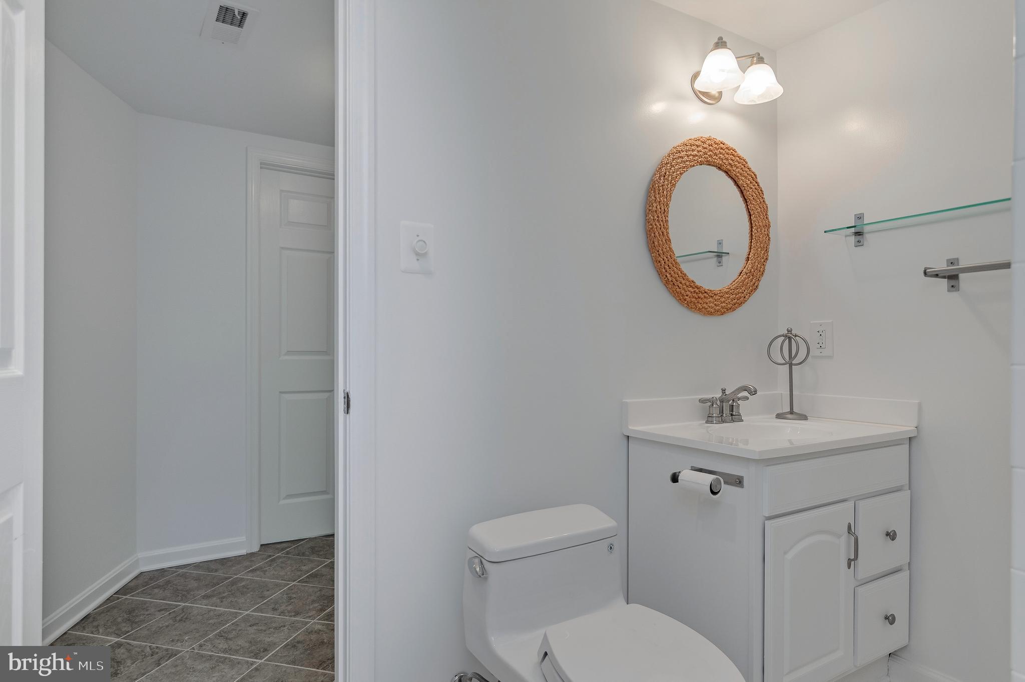 4043 20th Road North Arlington, VA 22207 - Photo 48 of 56 a bathroom with a toilet a sink and a mirror