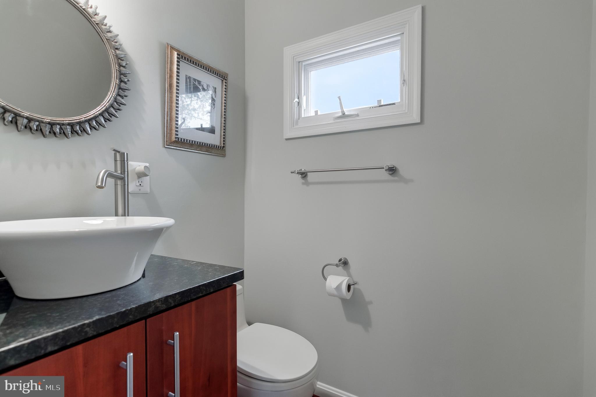 4043 20th Road North Arlington, VA 22207 - Photo 6 of 56 a bathroom with a toilet a sink and mirror