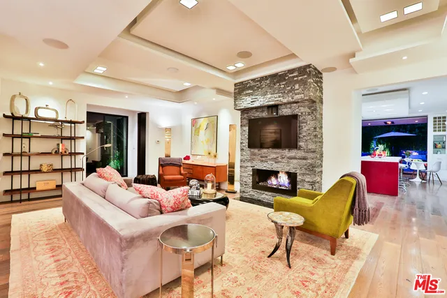 a living room with furniture fireplace and flat screen tv