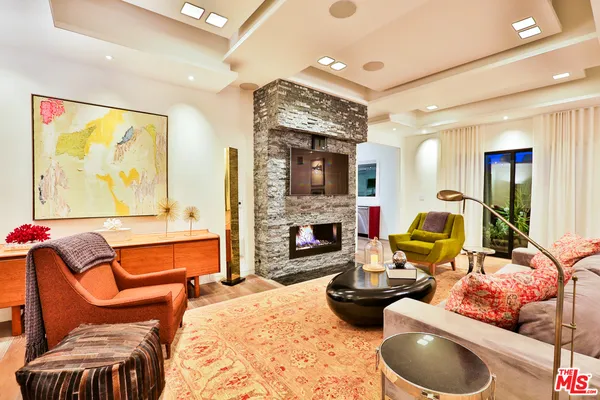 a living room with furniture flat screen tv and a fireplace