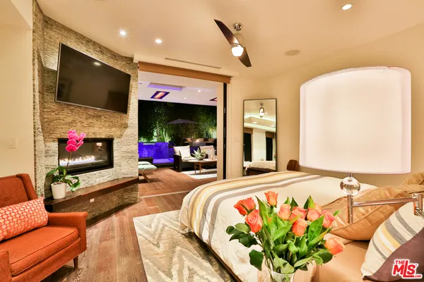 a bedroom with a bed and painting on the wall