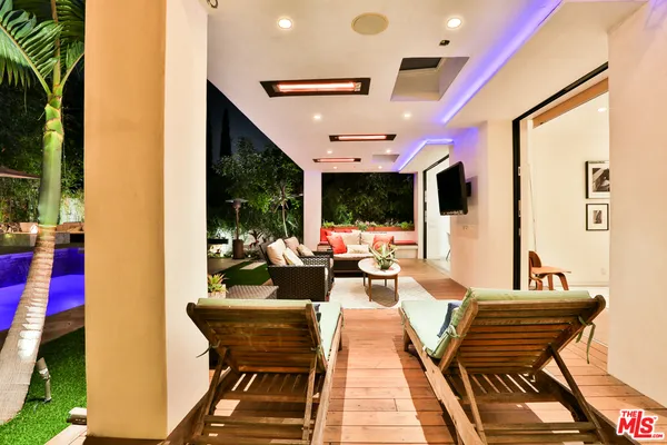 a view of balcony with wooden floor and outdoor seating