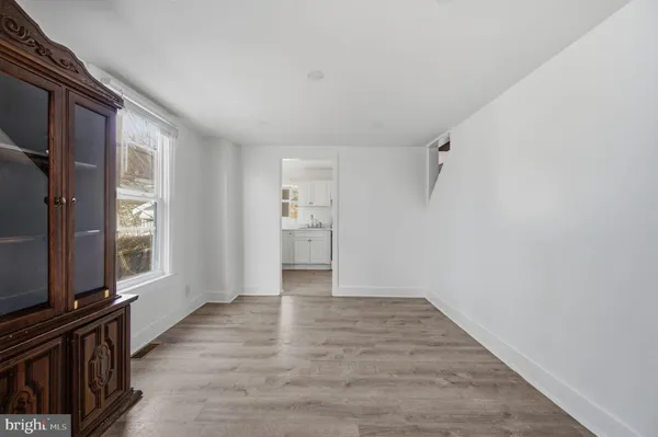 a kitchen with white cabinets a sink and appliances