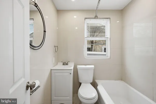 a bathroom with a granite countertop toilet sink and shower