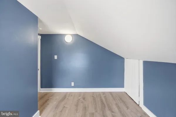 a bathroom with a granite countertop sink and washing machine