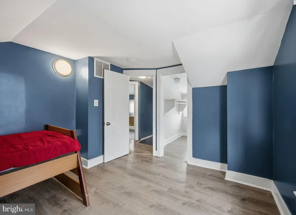 a bedroom with a bed and a mirror