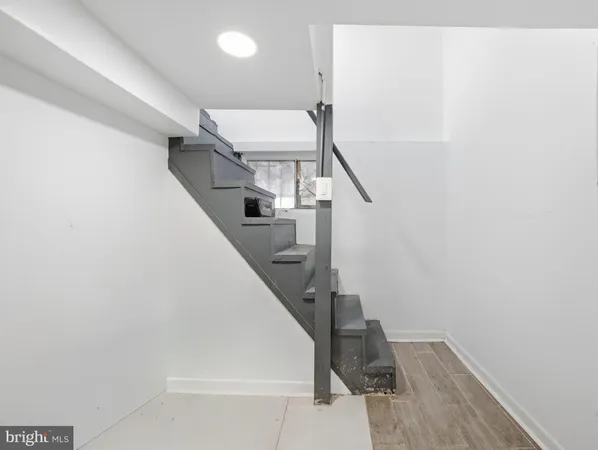 a view of a house with wooden deck and trees