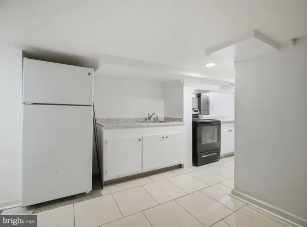 a street view covered with snow in front of house