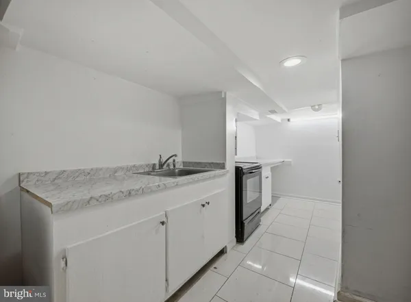 a front view of a house with a tree