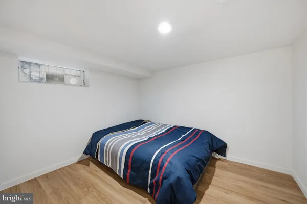 a picture of a bench in front of a wall