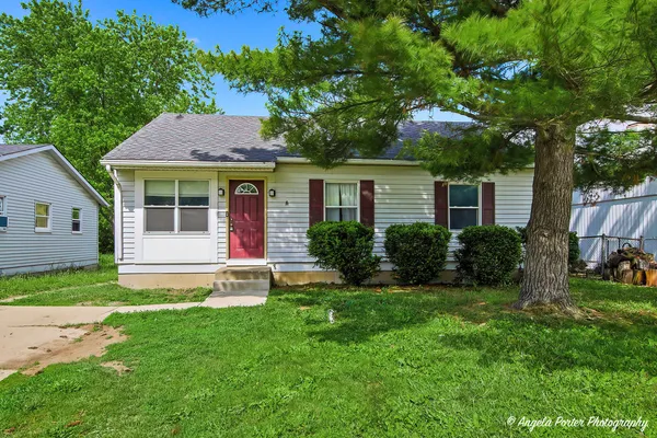 a view of a house with a yard and plants
