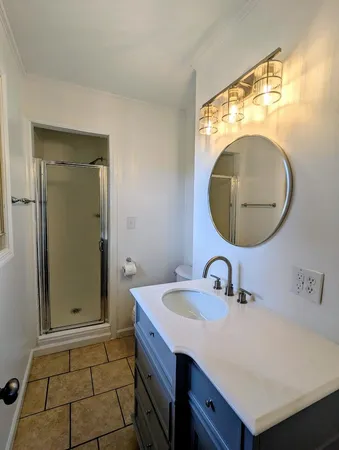 a bathroom with a sink mirror and vanity