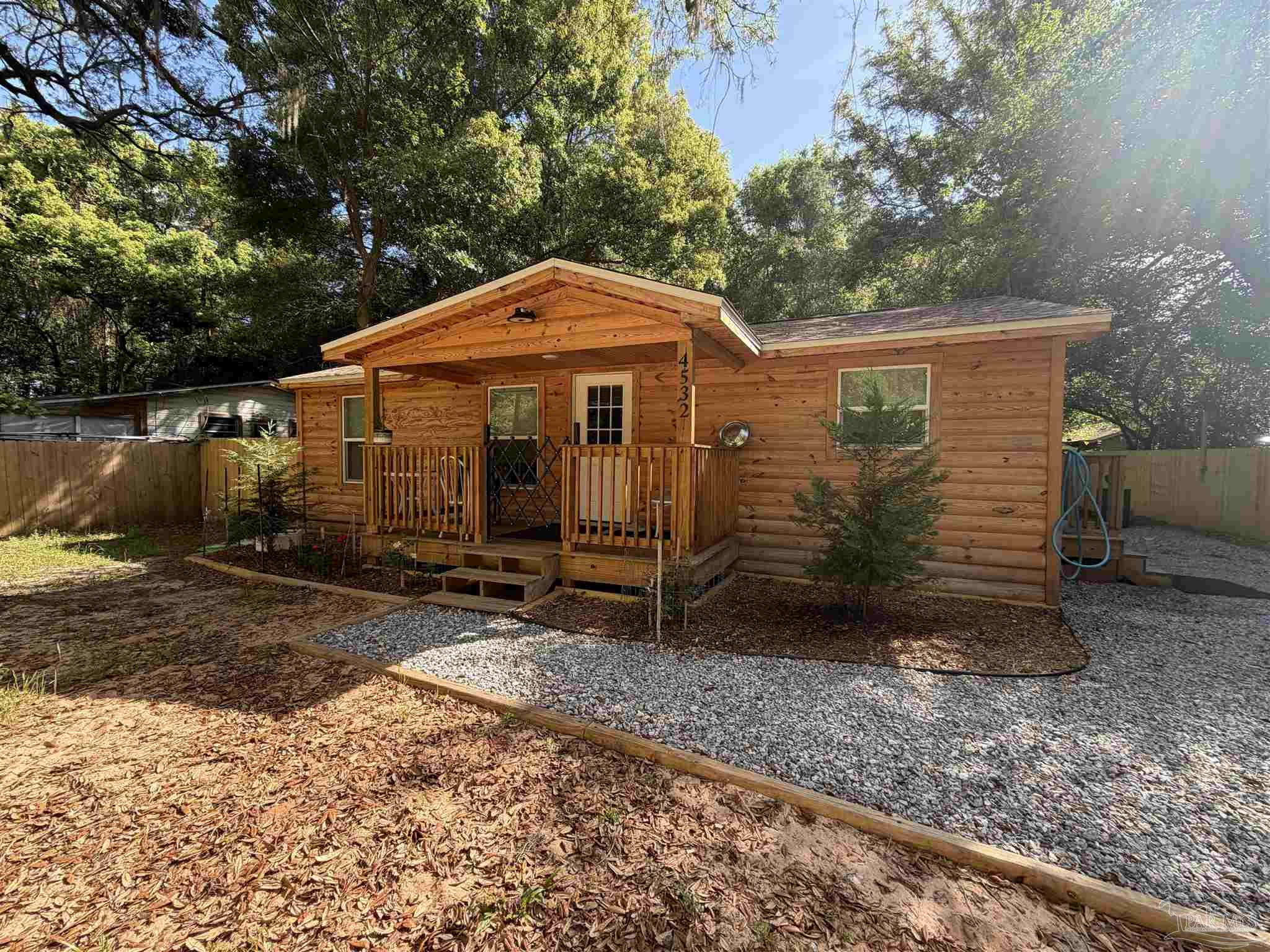 4532 Limit Street Milton, FL 32583 - Photo 1 of 18 a view of a small house covered with trees in the background