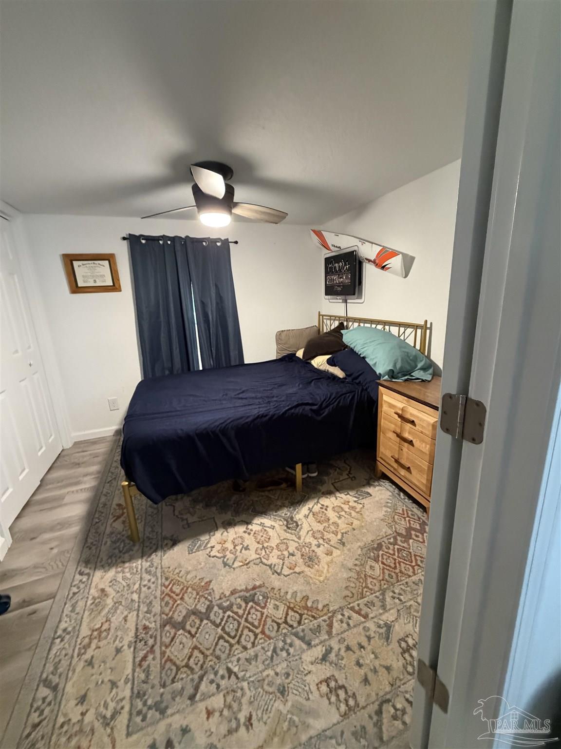 4532 Limit Street Milton, FL 32583 - Photo 11 of 18 a bedroom with a bed and wooden floor
