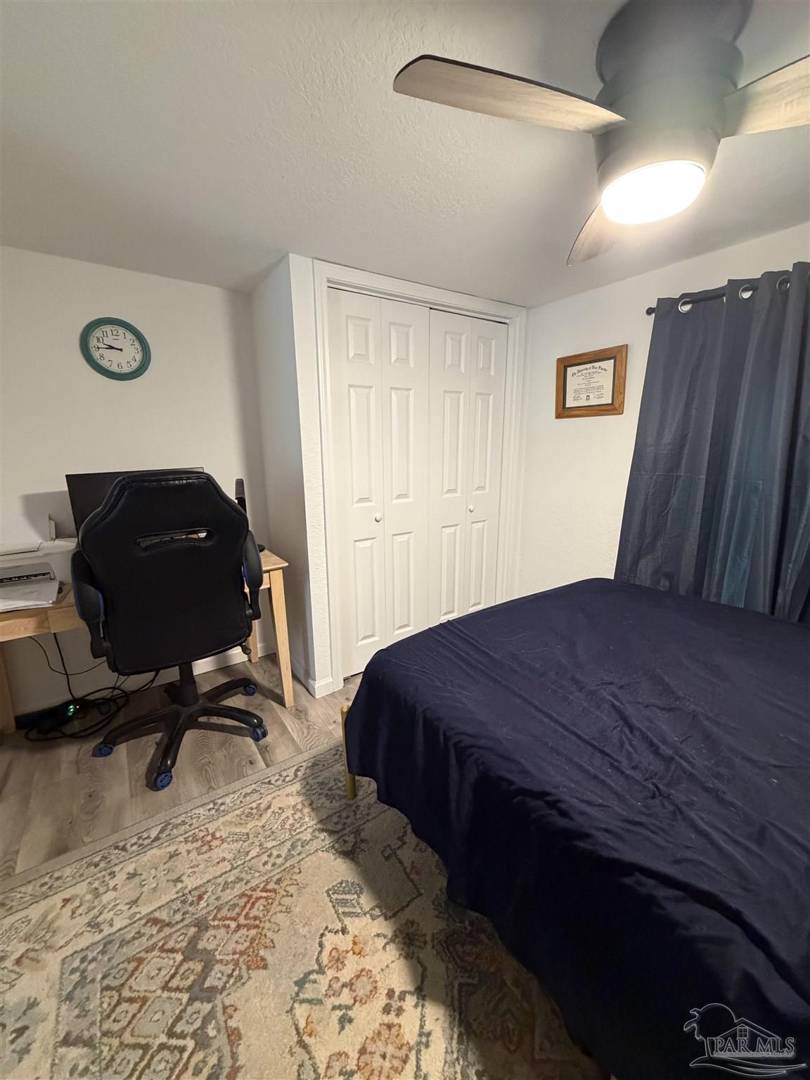 4532 Limit Street Milton, FL 32583 - Photo 12 of 18 a bedroom with a bed and a chair
