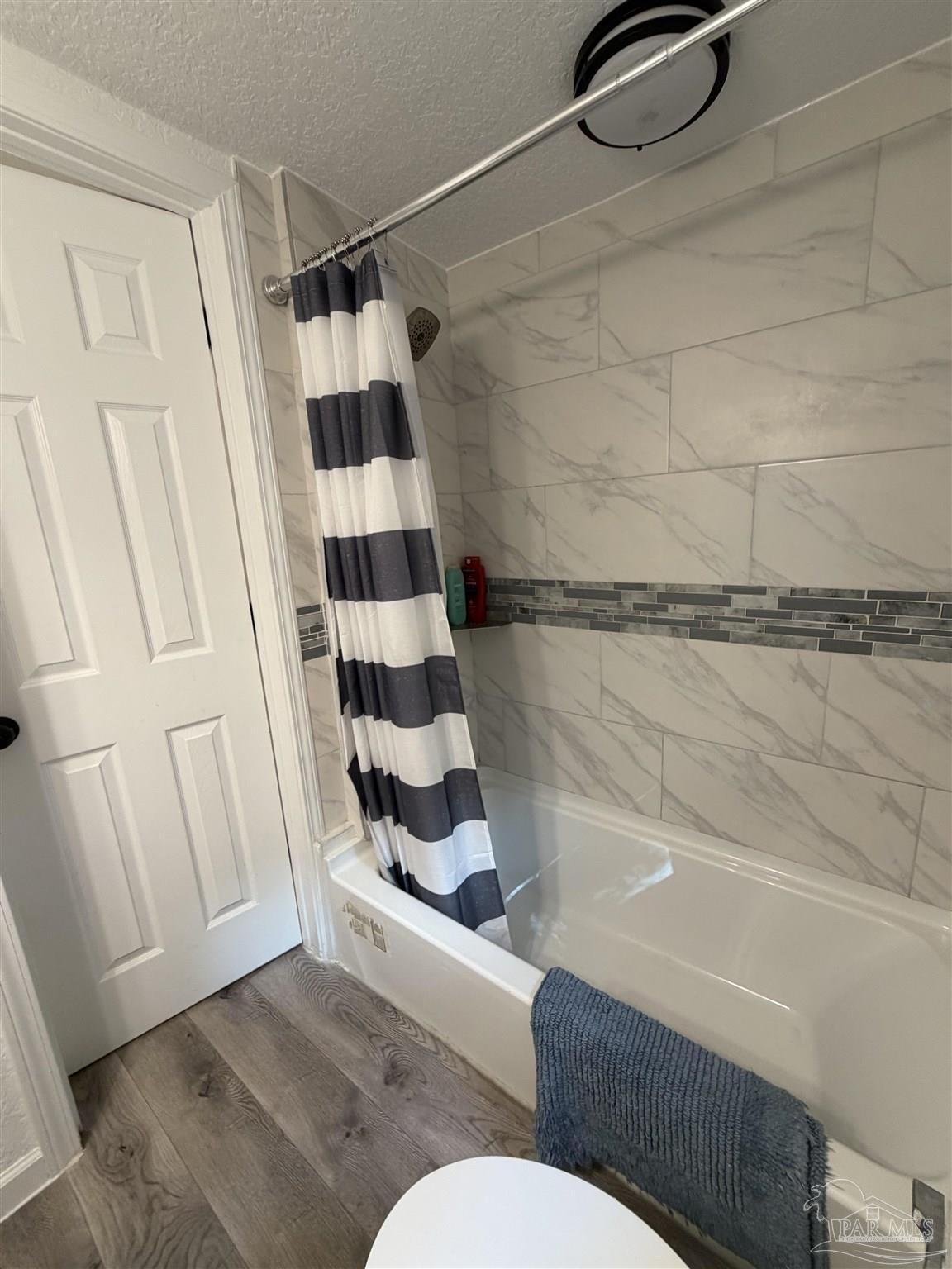 4532 Limit Street Milton, FL 32583 - Photo 14 of 18 a bathroom with a shower and a sink