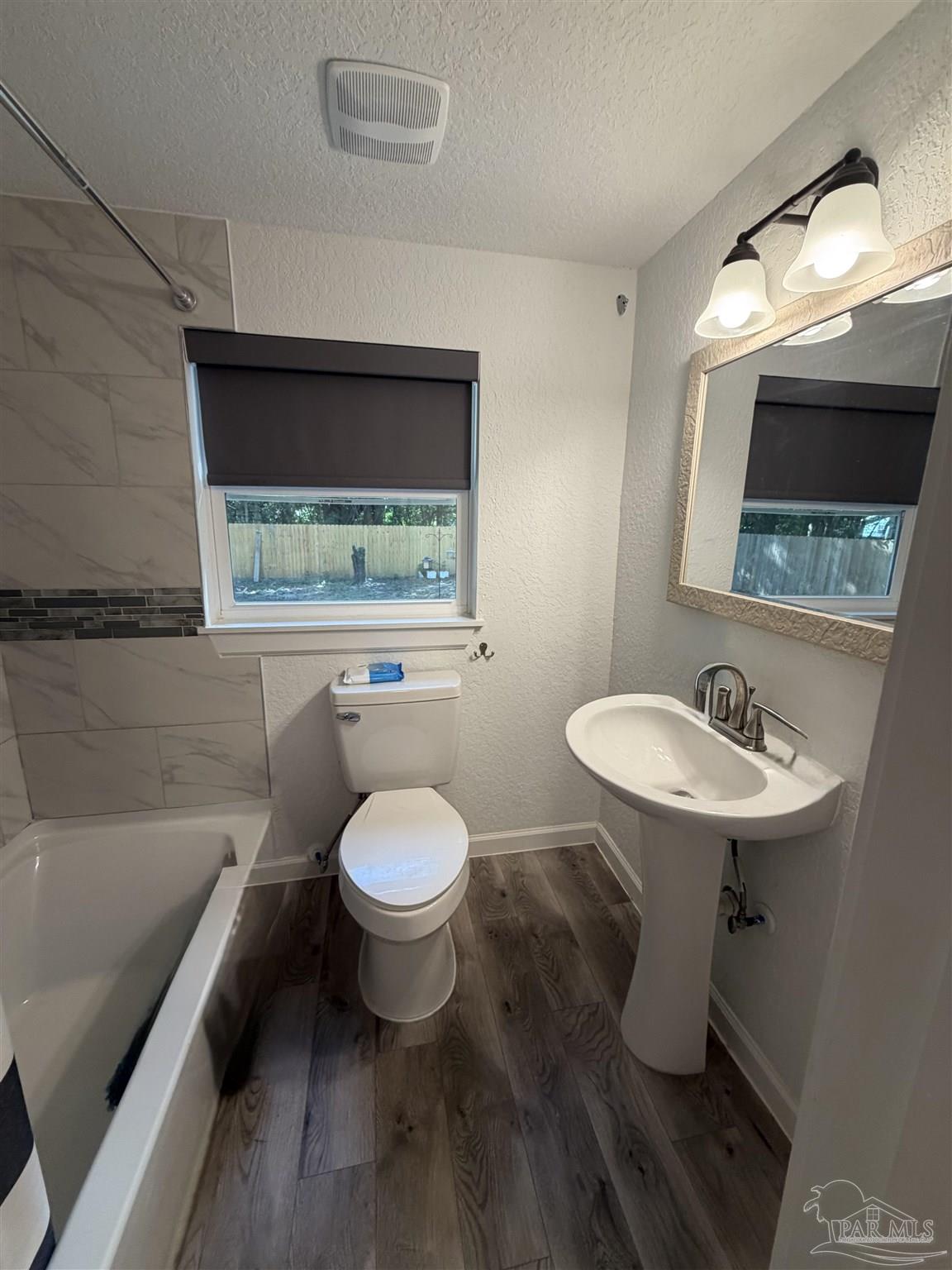 4532 Limit Street Milton, FL 32583 - Photo 16 of 18 a bathroom with a sink a toilet and bathtub