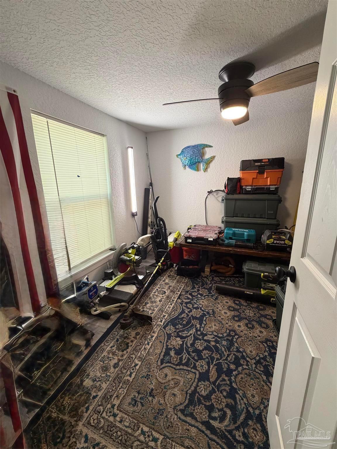 4532 Limit Street Milton, FL 32583 - Photo 17 of 18 a room with furniture and a flat screen tv