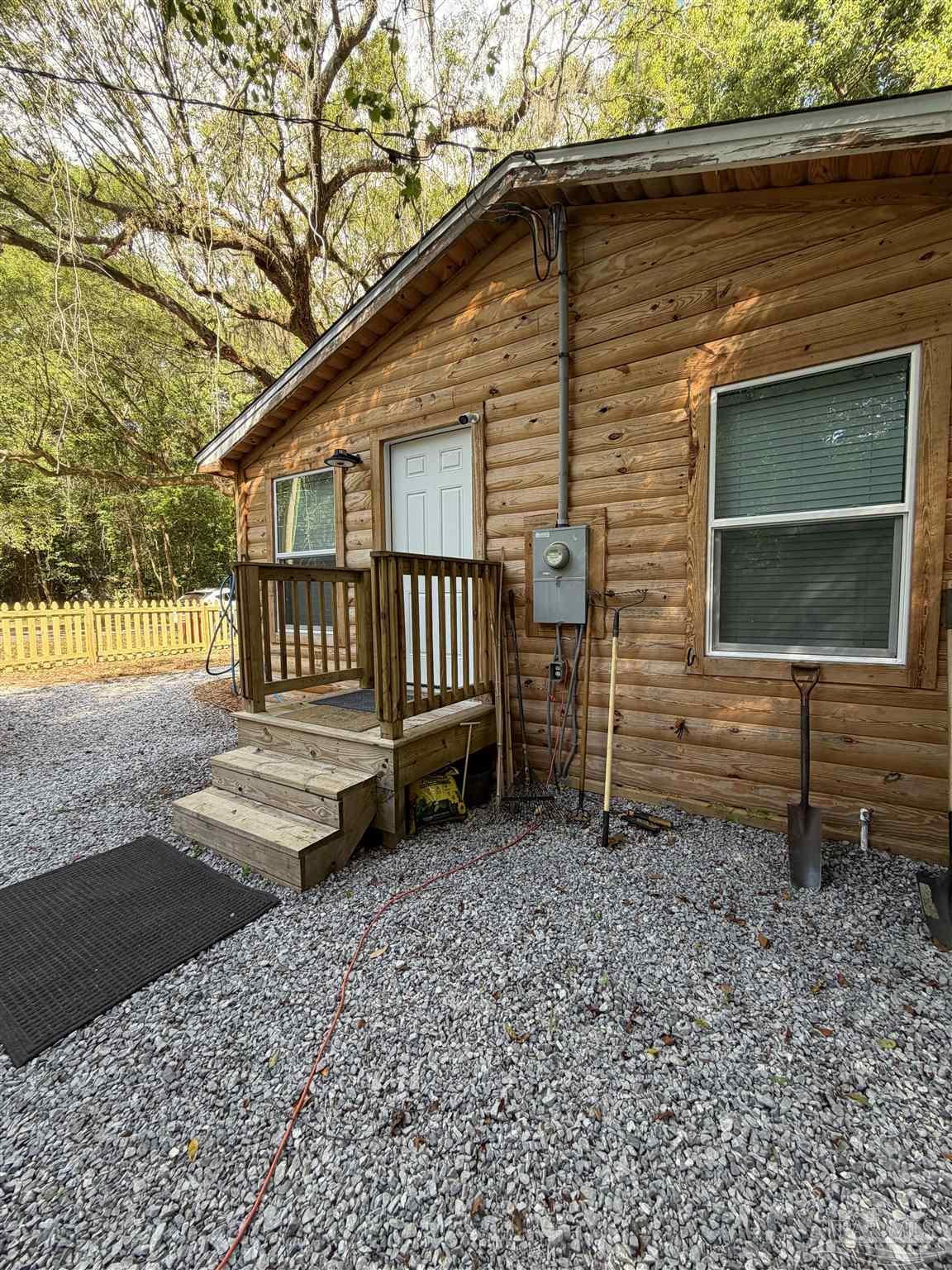 4532 Limit Street Milton, FL 32583 - Photo 5 of 18 a front view of a house with a yard