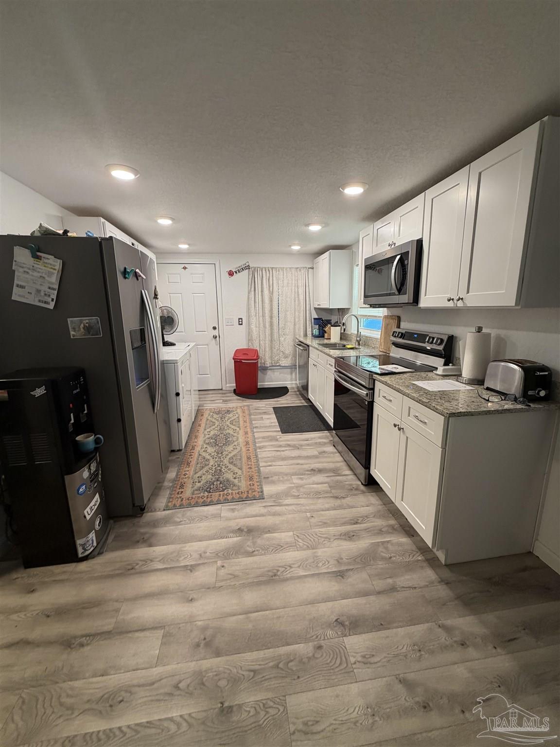 4532 Limit Street Milton, FL 32583 - Photo 7 of 18 a kitchen with stainless steel appliances granite countertop a refrigerator sink and microwave