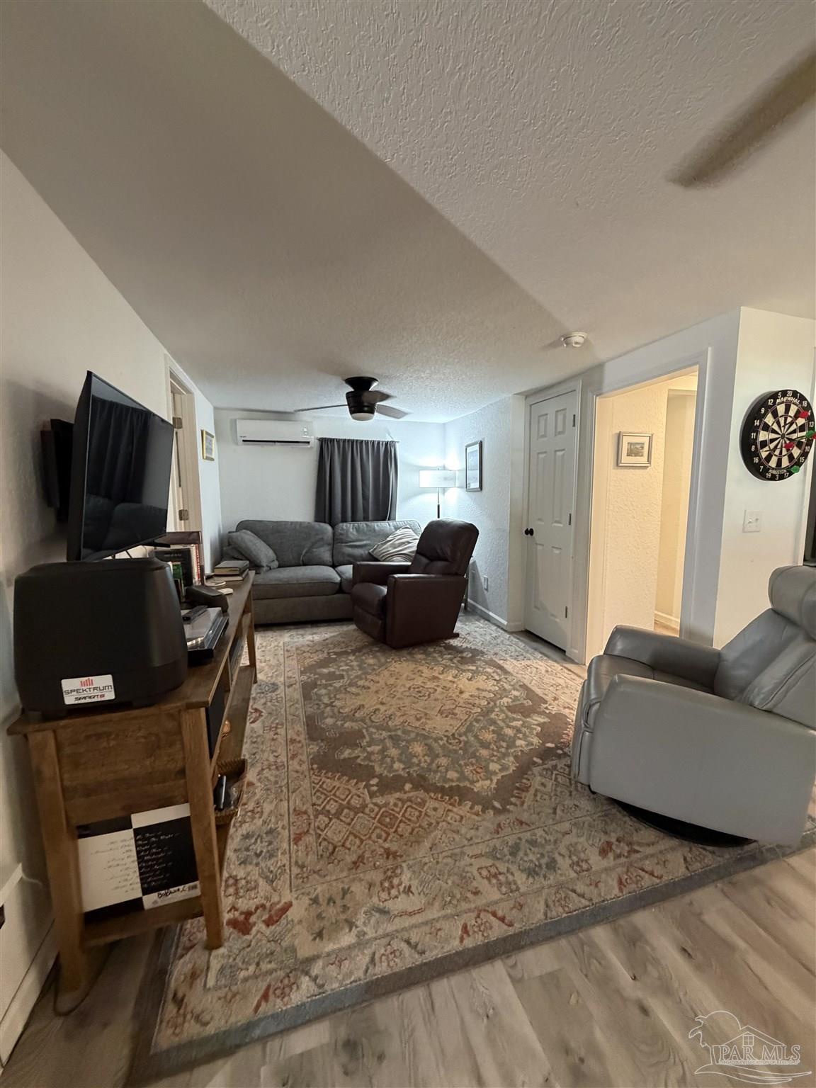 4532 Limit Street Milton, FL 32583 - Photo 9 of 18 a living room with furniture and a flat screen tv