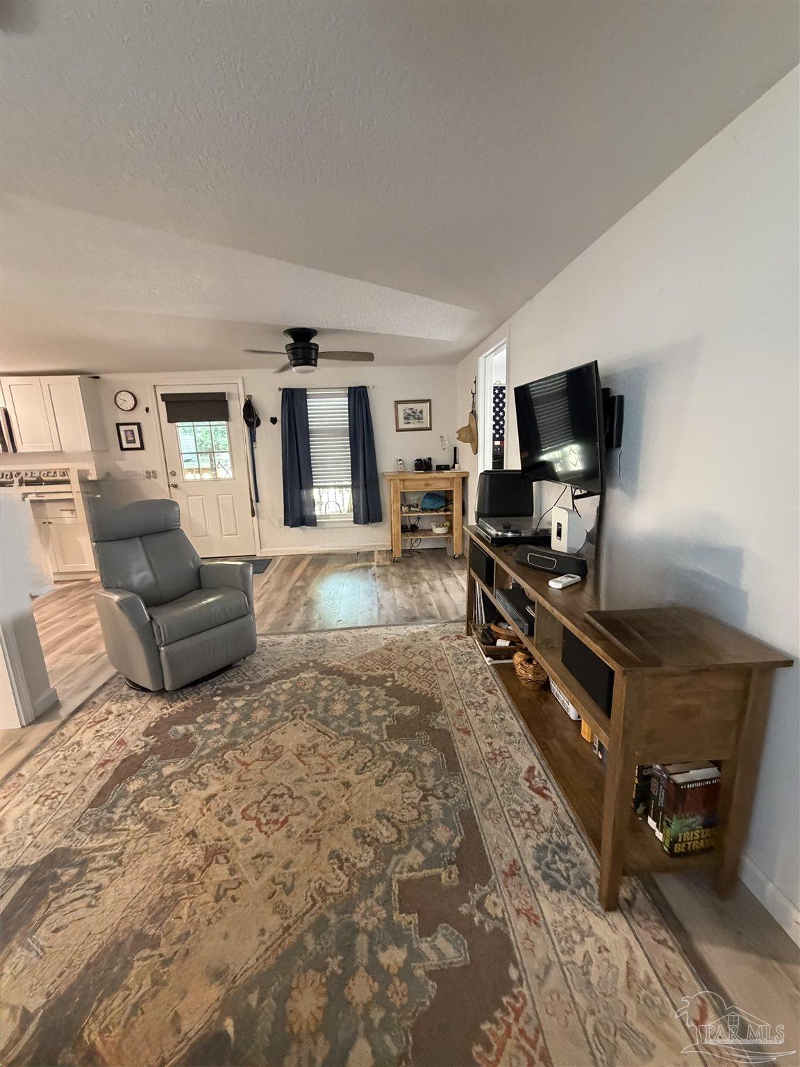 4532 Limit Street Milton, FL 32583 - Photo 10 of 18 a living room with furniture and a flat screen tv